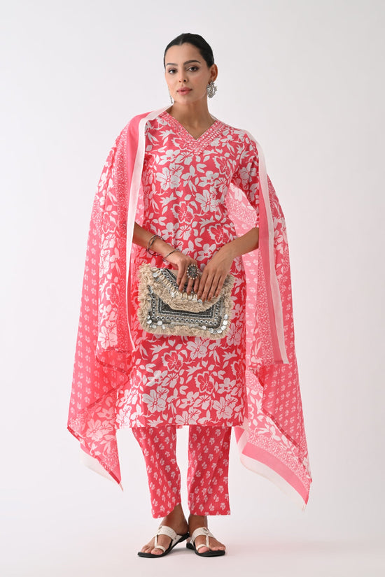 Woman wearing a red and white floral outfit with a matching dupatta on a white background
