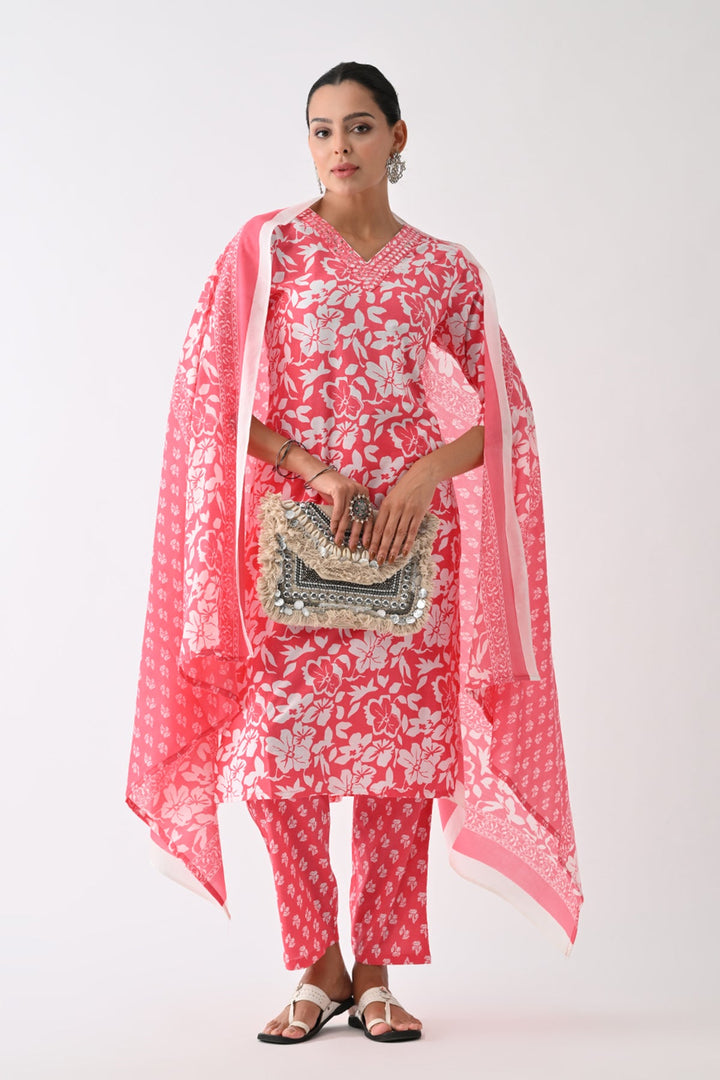 Woman wearing a red and white floral outfit with a matching dupatta on a white background